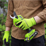A person wearing a brown button-up shirt and black pants holds a Greenworks cordless pruning shears in their gloved hands. The person is also wearing matching neon green and black gardening gloves.