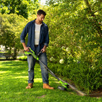Man using a cordless grass trimmer in a garden